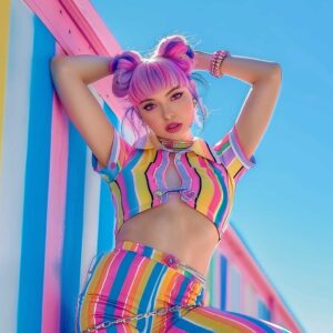 Femboy influencer posing for a TikTok video in a colorful outfit, representing the role of social media and TikTok in femboy fashion.